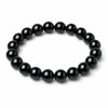 Simple black obsidian bead bracelet on a white background