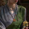 Tibetan Mini Tsa-Tsa Thangka Pendant — Hand-Painted Sacred Icon in Leather Casing Buddha Tibet